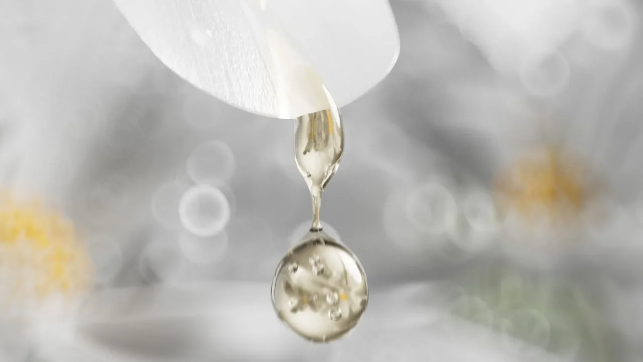 Serum drop falling from a petal tip, photorealistic 3D